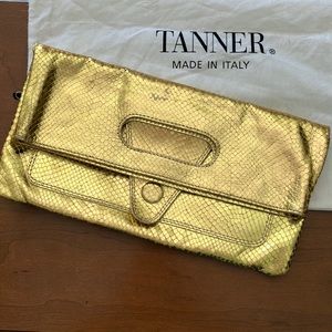 Tanner metallic gold leather clutch purse.